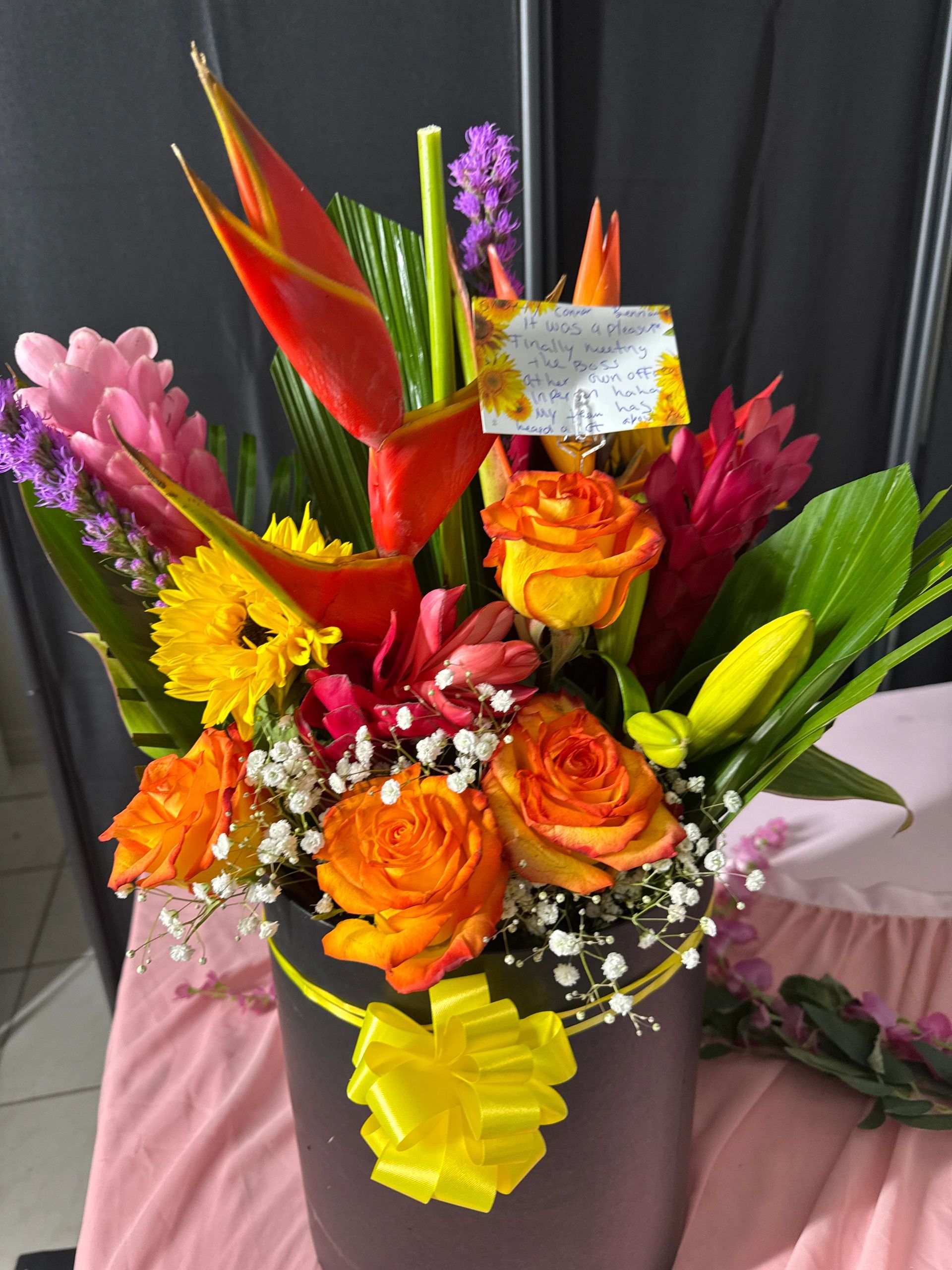 Vibrant tropical bouquet with orange roses and yellow gerberas